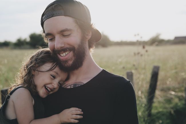 a dad and daughter laughing
