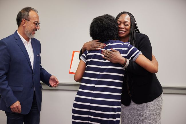 Claudio Martinez and Associate Professor Margaret Lombe, director of the BRIDGE program, congratulate a graduate