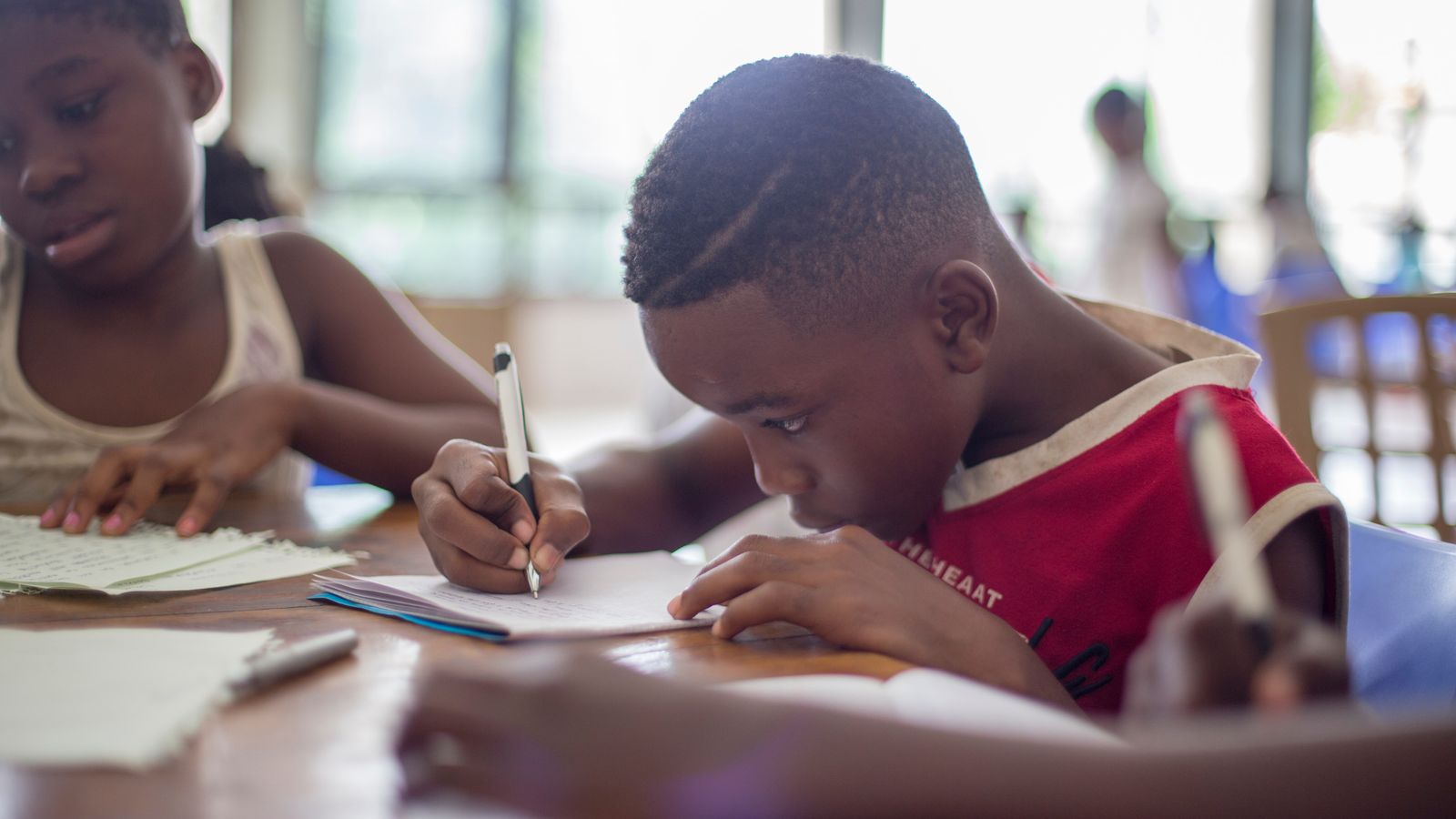 Student doing classwork at table