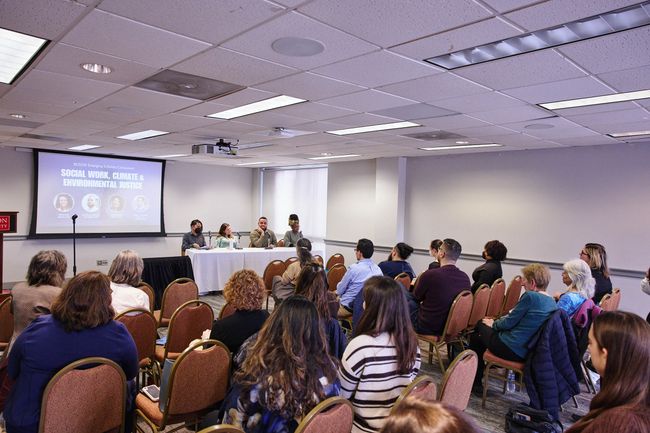 Audience and speakers at Emerging Scholars event