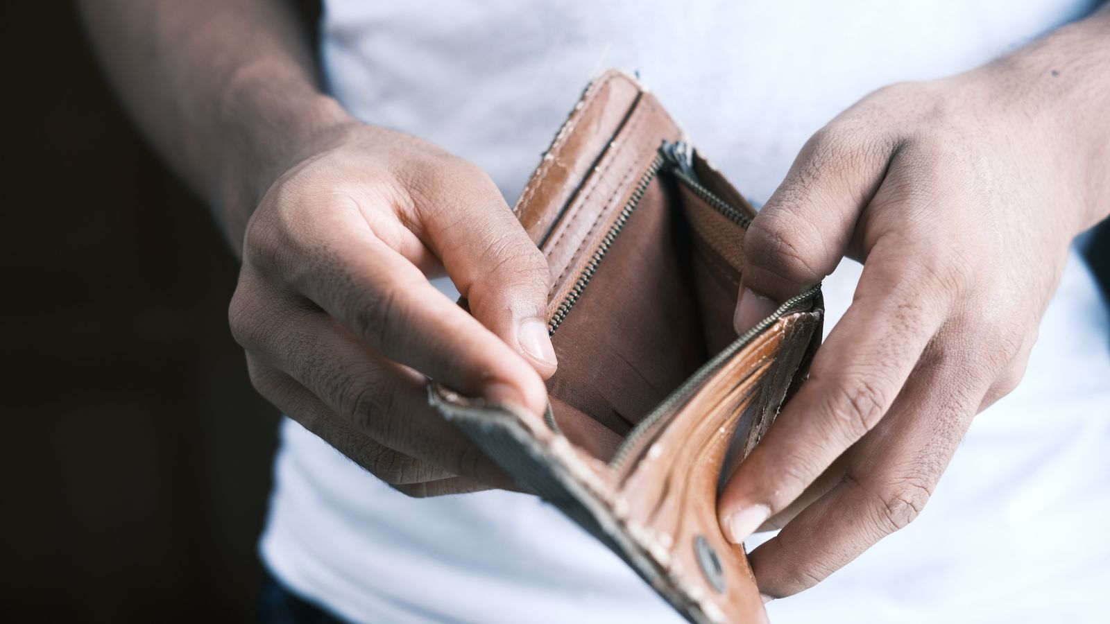 Hands opening empty wallet