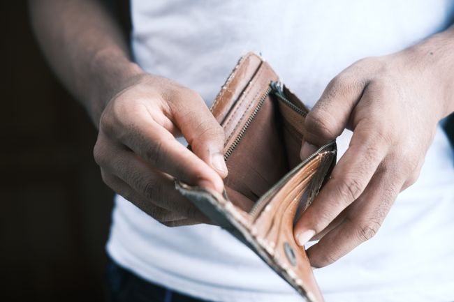 Hands opening empty wallet