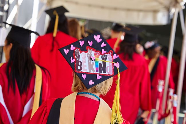Student graduation cap decorated with hearts and text reading Be Kind