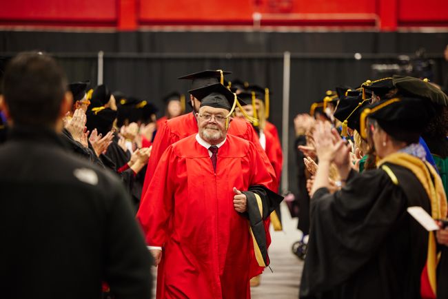 Graduating students process into the venue