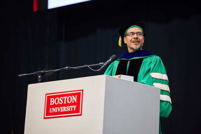 Dean Delva addresses graduates and guests from the podium
