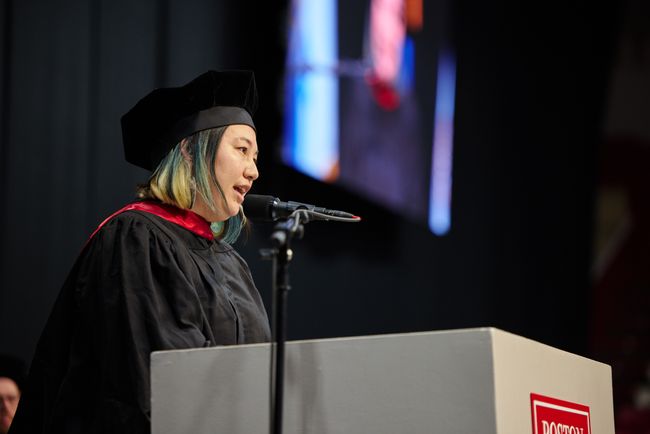 Commencement speaker Carolyn Chou addresses attendees from the podium