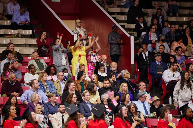 Guests cheer on graduates from the stands