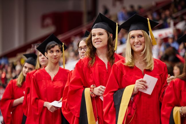 Graduates line up to cross the stage