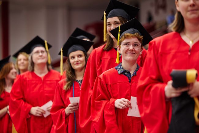 Graduates wait in line for their hooding and diploma