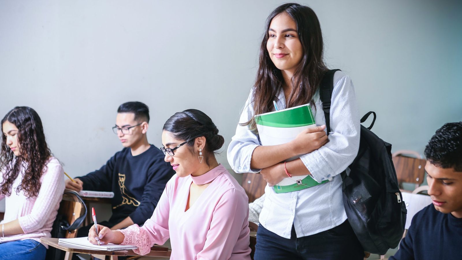 a college student walking into a classroom