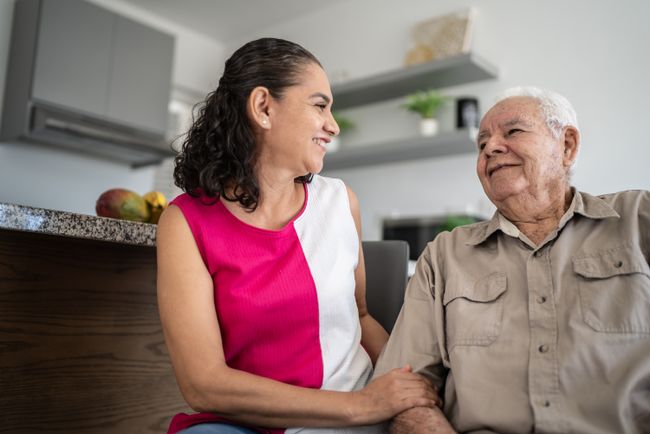 Older man and younger woman sitting together