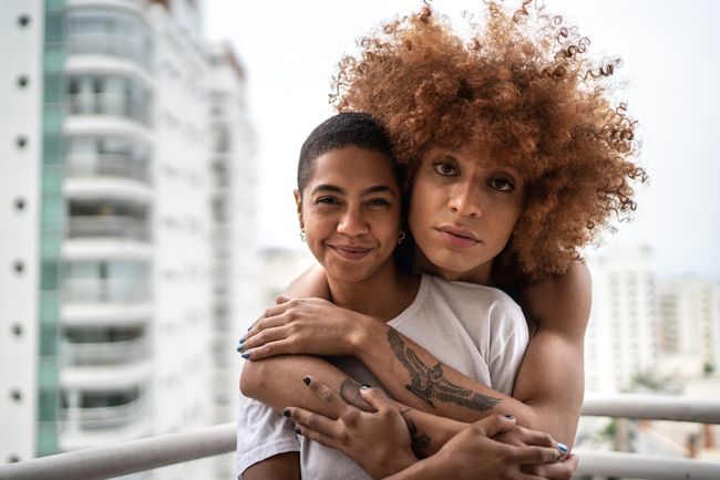 two latinas hugging each other