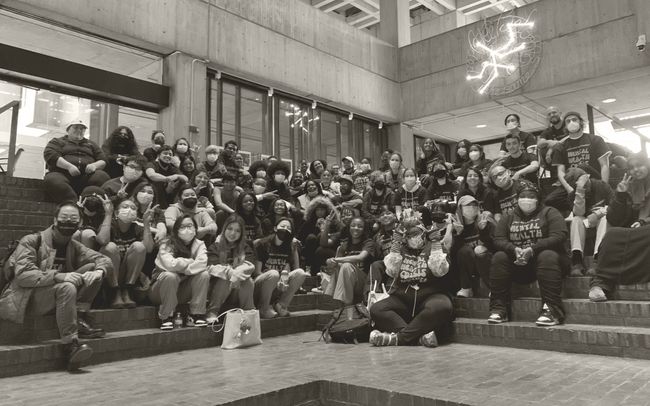 Black and white photo of dozens of young people posing for picture in Mental Health Crisis Response t-shirts