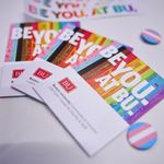 Photo of LGBTQIA+ Center pins and postcards on event table