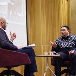 Photo of the event moderator and author on stage