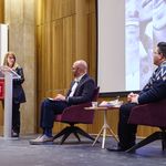 Photo of BUSSW Dean Barbara Jones at podium with moderator and author seated on stage