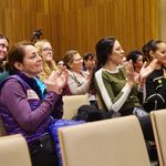 Photo of audience members clapping