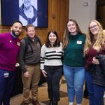 Event attendees posing for a photo during the reception