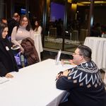 Prof. Alvarez-Hernandez at book signing speaking to attendee at front of the line