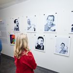Attendees viewing the See Me! photo exhibit