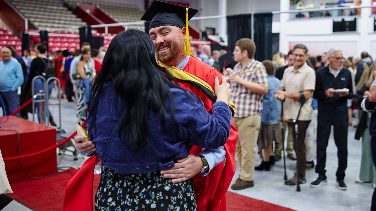 Andrew Stringer graduate and fiancee embracing