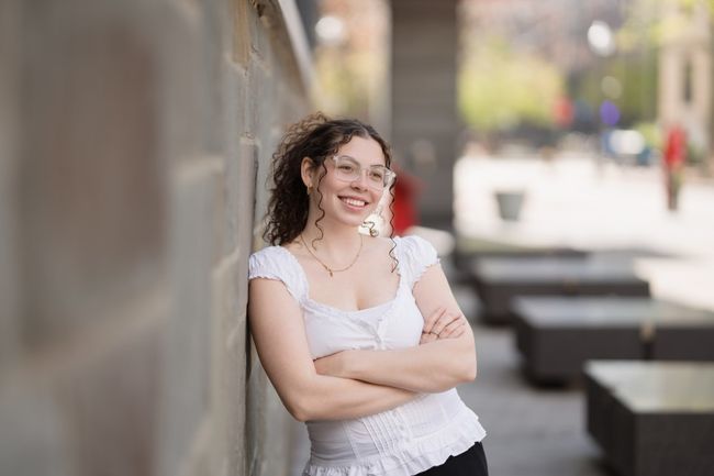 woman leaning on wall with arms crossed