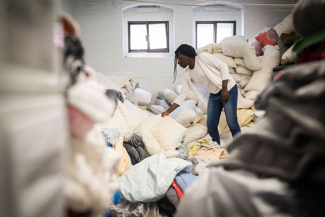 African American woman moves a bag of textiles