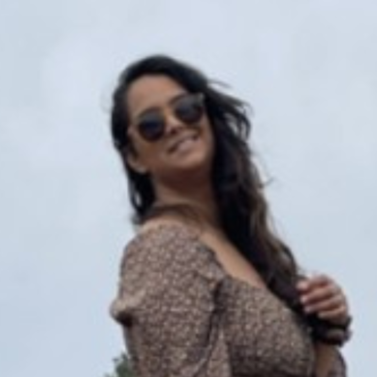 woman poses in a field