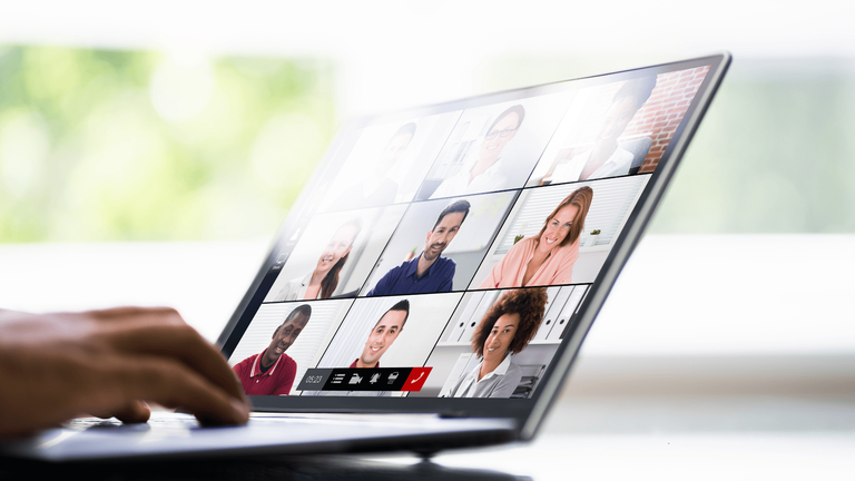 multiple faces on laptop screen during online meeting or event