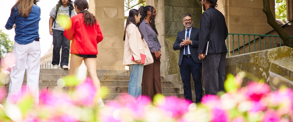 dean of academic affairs talking outside with students on campus