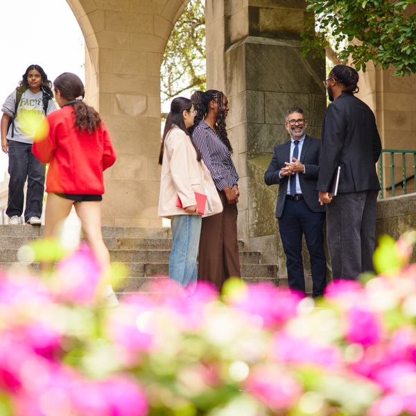 dean of academic affairs talking outside with students on campus