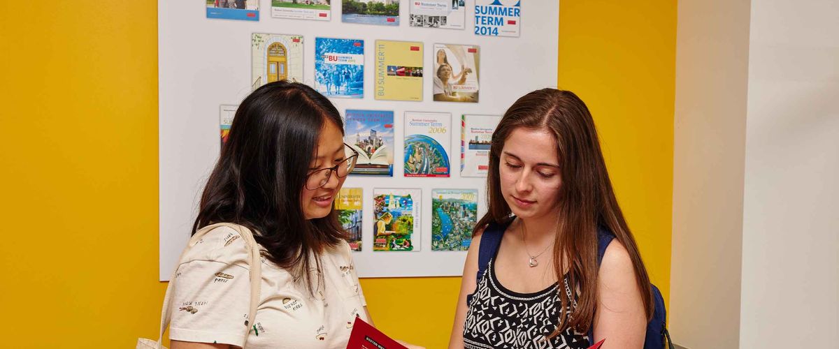Boston University students look through a folder