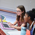 Two students working on a laptop in a classroom - Introduction to Experimental Psychology