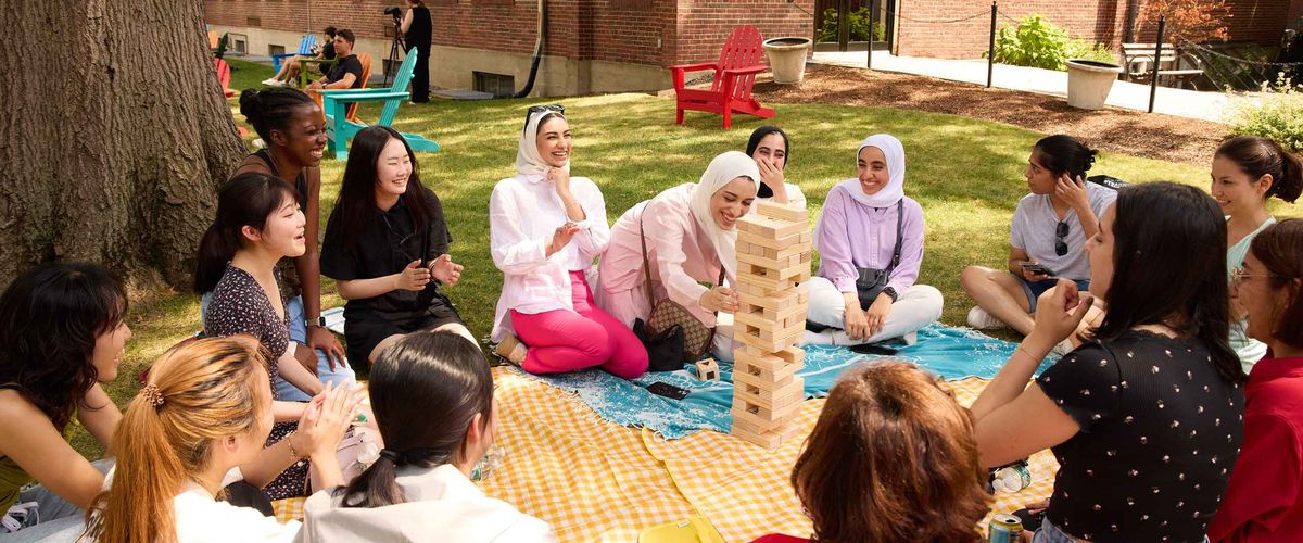 Boston University students playing Jenga outdoors - Health Records & Medical Insurance