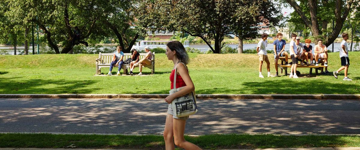 A Boston University student walks along BU Beach.