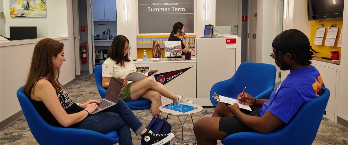 An image of the Boston University Summer Term Office with people filling out paperwork