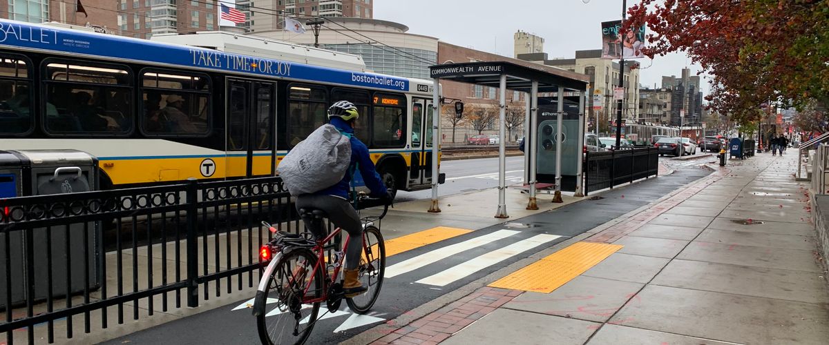 Biking on the Comm Ave cycletrack as an MBTA bus passes