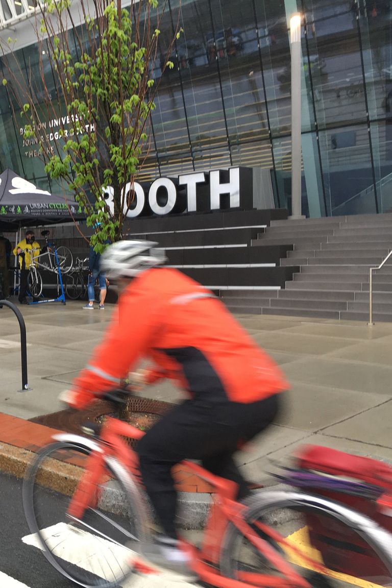 Biking in front of Booth Theatre
