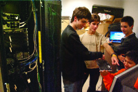 Boston University undergraduate students Michael Abed, Darko Stosic, Dusan Stosic, and Terry Black preparing for the SC11 Student Cluster Competition