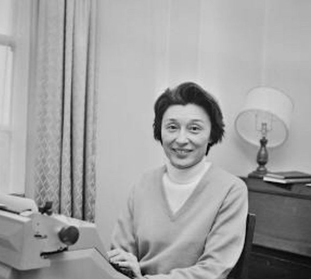 Han Suyin sitting behind her typewriter.