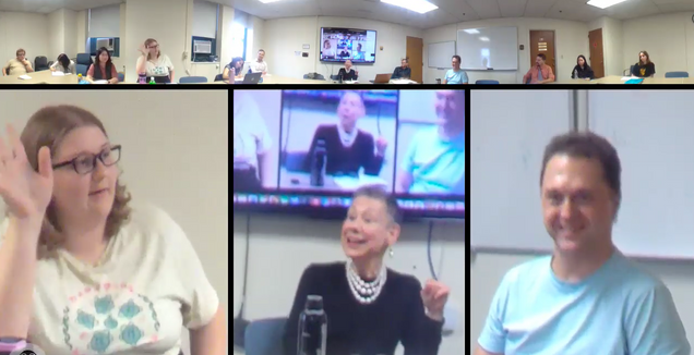 Students it around table with Harris at workshop.