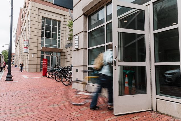 Entering building with bicycle