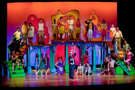 Student actors on colorful Seussical stage