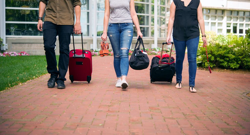 People walking with rolling suitcases