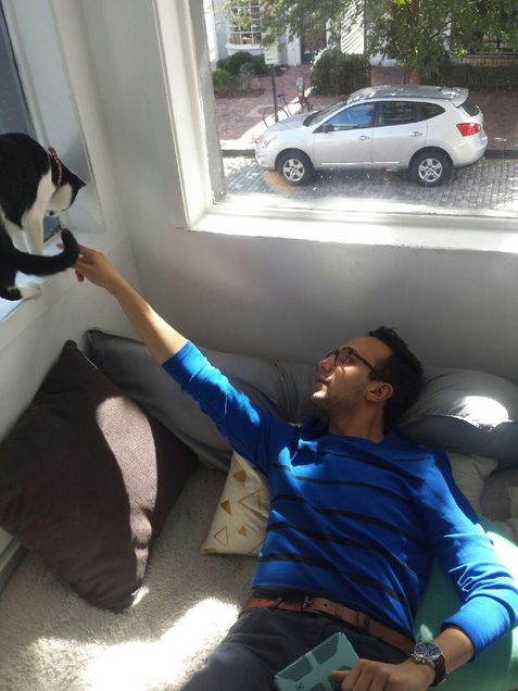 Attempting to get my furry friend's attention as he crawls along the window sill of Crumbs & Whiskers. Photo taken by Francisco Perez.