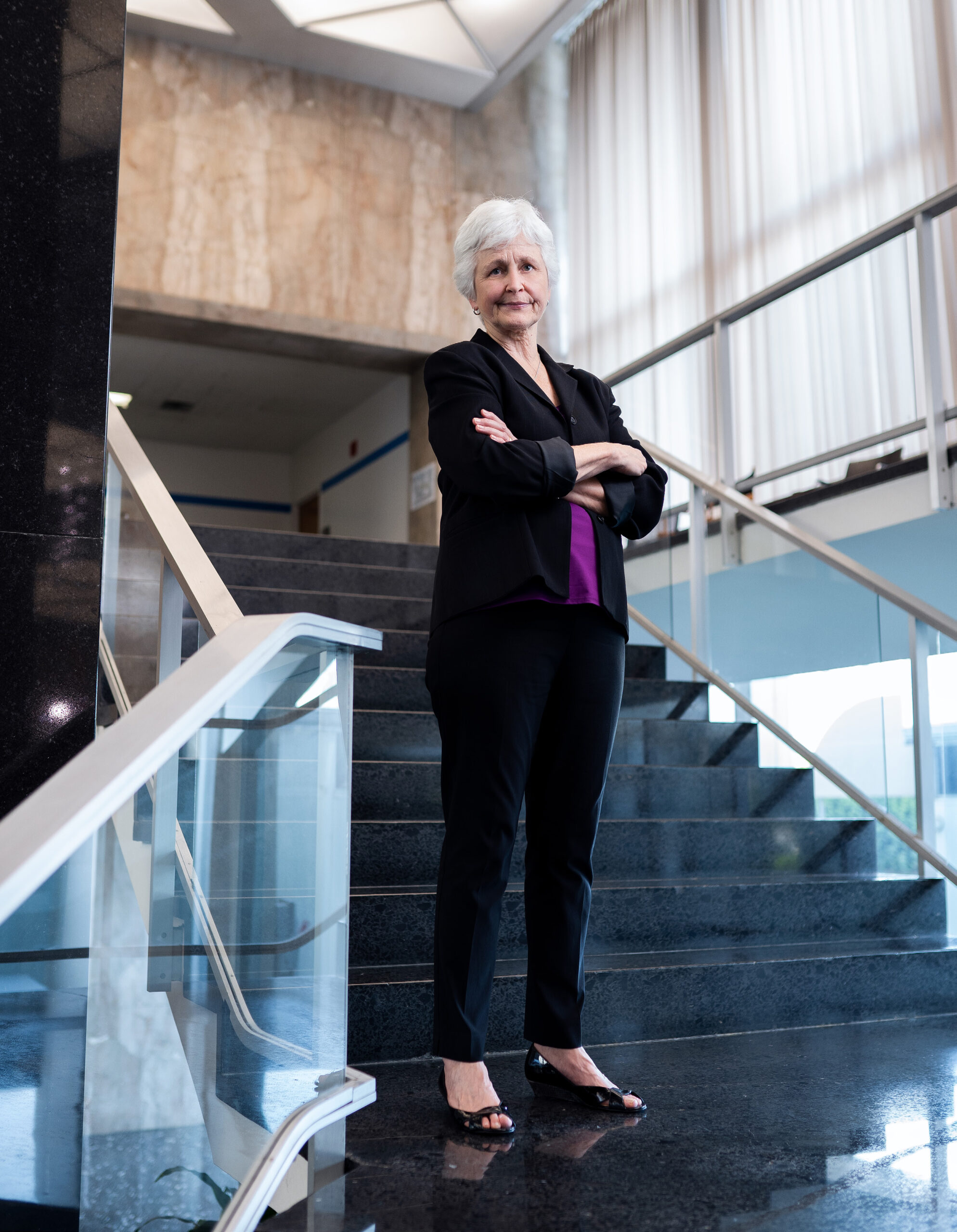 Jane Sigmon standing of a set of steps with her arms crossed