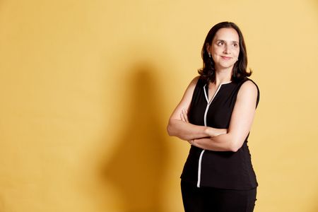 Jennifer Greif Green posed infront of yellow backdrop