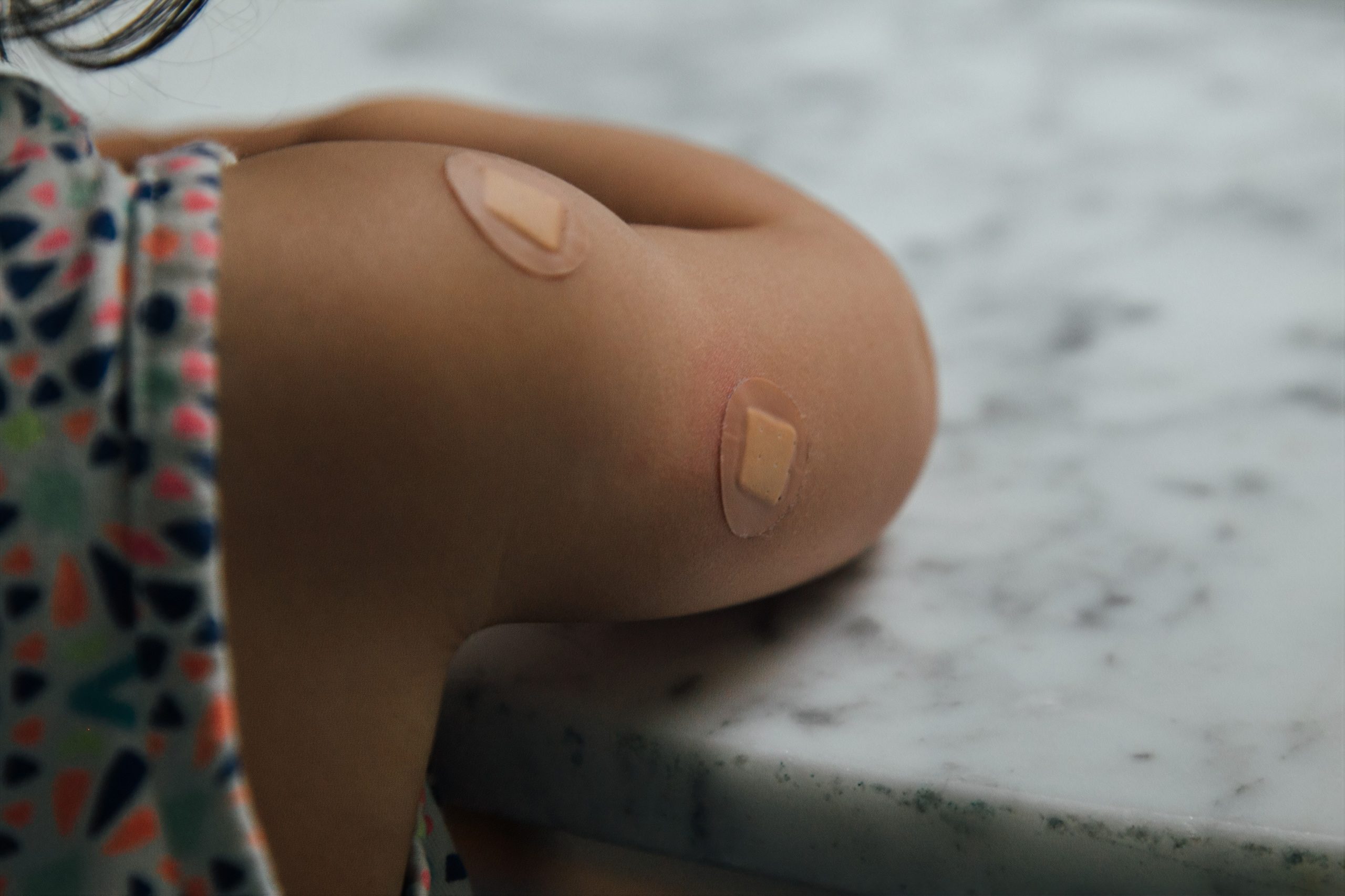Child arm with bandaid after shot