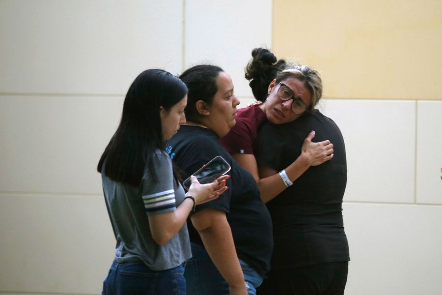 A group of people crying and embracing each other.