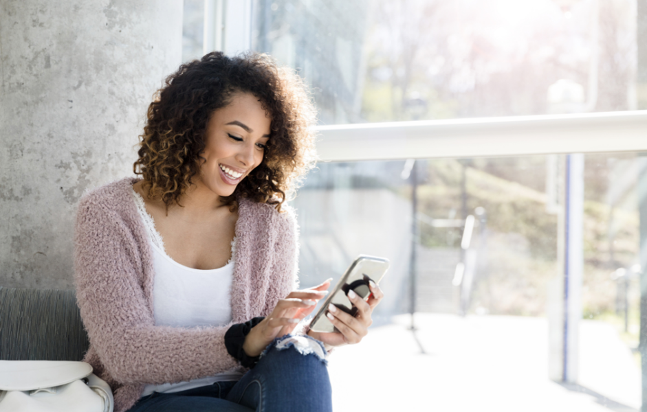 Shows a woman on a smartphone